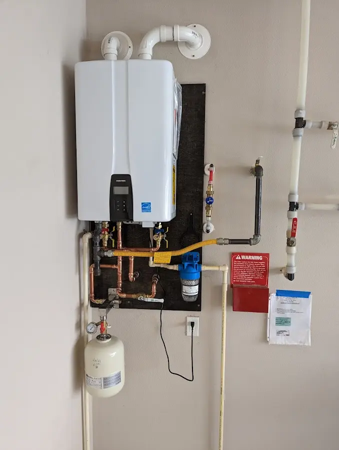 Professional plumber installing copper piping in a Pound Ridge home